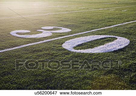 Stock Photo - Thirty yard line on green playing field. Fotosearch