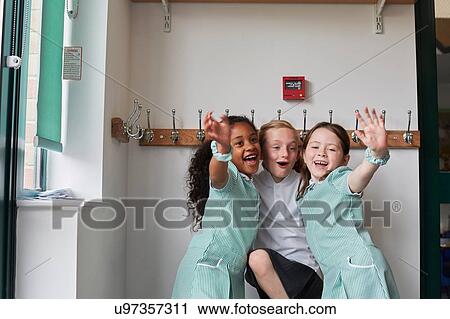 Three schoolgirls having fun in primary school cloakroom View Large Photo Image Stock Image - Three schoolgirls having fun in primary school cloakroom. Fotosearch