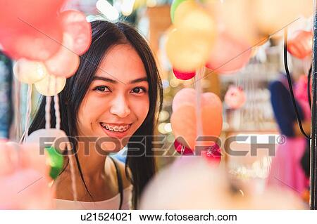 Tourist admiring decorative lights in bazaar, Bangkok, Thailand View Large Photo Image Stock Image - Tourist admiring decorative lights in bazaar, Bangkok, Thailand. Fotosearch