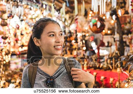 Stock Photograph - Tourist walking in bazaar, Bangkok, Thailand. Fotosearch