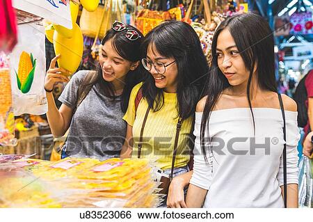 Stock Photograph - Tourists walking in bazaar, Bangkok, Thailand. Fotosearch