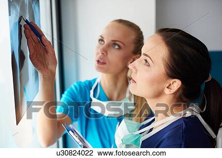 Two surgeons looking at x-ray View Large Photo Image Stock Image - Two surgeons looking at x-ray. Fotosearch