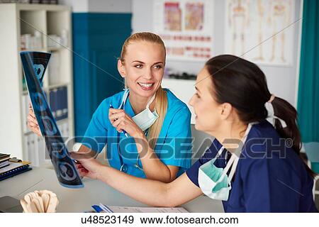 Two surgeons looking at x-ray View Large Photo Image Stock Photo - Two surgeons looking at x-ray. Fotosearch