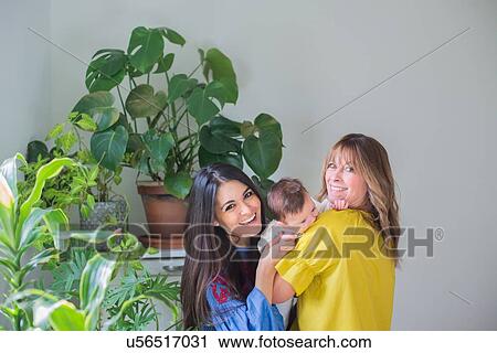 Stock Image - Two women with baby girl. Fotosearch