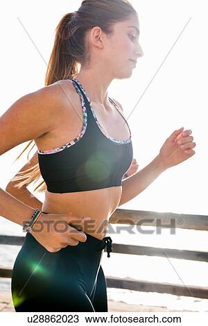 Two young female runners running on sea waterfront View Large Photo Image Stock Image - Two young female runners running on sea waterfront. Fotosearch