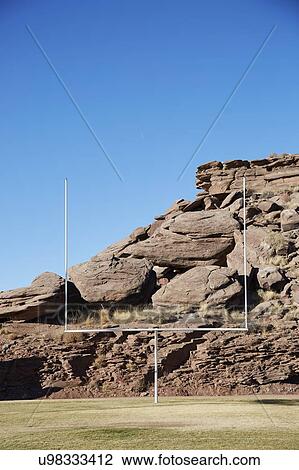 Stock Image - USA, Arizona, American football field goal with rocks in background. Fotosearch