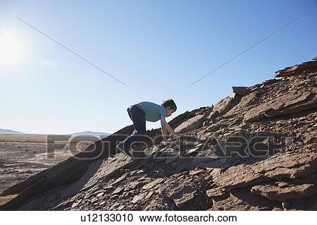 USA, Arizona, Boy (6-7) moving up on rock View Large Photo Image Stock Image - USA, Arizona, Boy (6-7) moving up on rock. Fotosearch