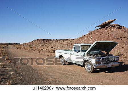 Stock Photo - USA, Arizona, Broken pick-up truck on desert road. Fotosearch