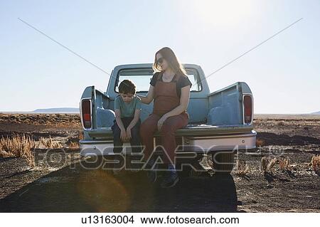 USA, Arizona, Mother comforting son (6-7) on tailgate of pick-up truck View Large Photo Image Picture - USA, Arizona, Mother comforting son (6-7) on tailgate of pick-up truck. Fotosearch