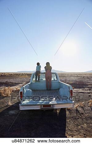Stock Image - USA, Arizona, Mother with boy (6-7) looking at view from pick-up truck. Fotosearch