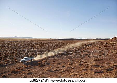 Stock Image - USA, Arizona, Pick up truck going through desert on Route 66. Fotosearch