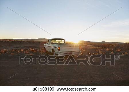 Stock Photo - USA, Arizona, Pick-up truck on desert road. Fotosearch