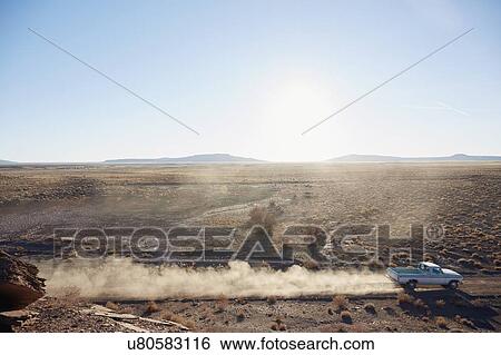 Stock Photograph - USA, Arizona, Pick-up truck on desert road. Fotosearch