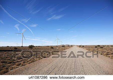 Stock Photograph - USA, Arizona, Wind turbines and road in arid landscape. Fotosearch