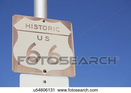 Stock Image - USA, Arizona, Winslow, Route 66 sign against blue sky. Fotosearch