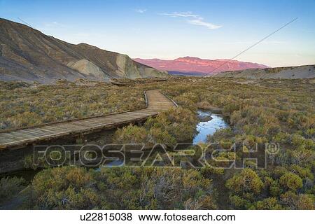 Stock Photo - USA, California, Death Valley National Park, Salt Creek, Boardwalk next to stream. Fotosearch