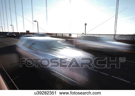Stock Image - USA, California, San Francisco, Golden Gate Bridge, Cars in blurred motion. Fotosearch