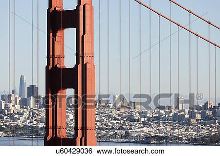 Stock Photograph - USA, California, San Francisco, Golden Gate Bridge with city skyline in background. Fotosearch