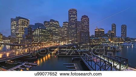 Stock Image - USA, Massachusetts, Boston, City waterfront panorama at dusk. Fotosearch