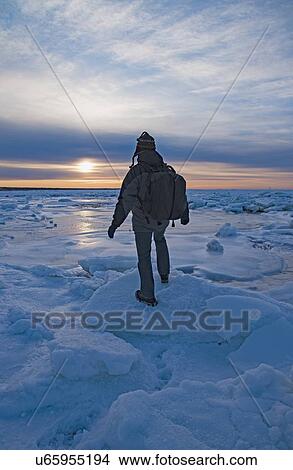 USA, Massachusetts, Cape Cod, Eastham, Man balancing on sea ice at dusk View Large Photo Image Picture - USA, Massachusetts, Cape Cod, Eastham, Man balancing on sea ice at dusk. Fotosearch
