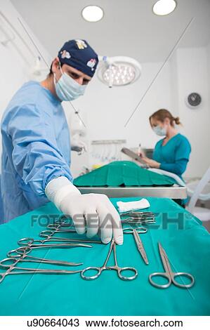 Stock Image - Vets performing operation in surgery. Fotosearch
