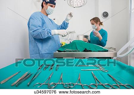 Stock Photograph - Vets performing operation in surgery. Fotosearch
