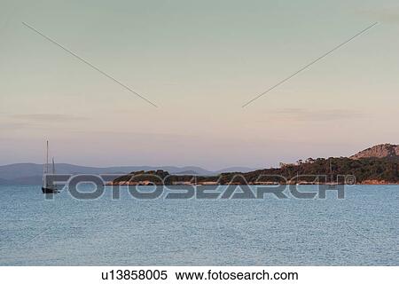 View of coast and anchored yacht, Porquerolles, Provence-Alpes-Cote d'Azur View Large Photo Image Stock Photography - View of coast and anchored yacht, Porquerolles, Provence-Alpes-Cote d'Azur. Fotosearch