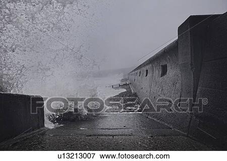 Stock Photo - Water crashing against sea wall, Seaham Harbour, Durham, UK. Fotosearch