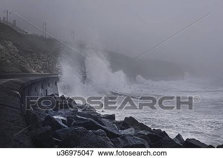 Stock Photo - Water crashing against sea wall, Seaham Harbour, Durham, UK. Fotosearch