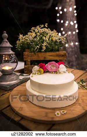 Wedding cake decorated with flowers on wooden board View Large Photo Image Stock Image - Wedding cake decorated with flowers on wooden board. Fotosearch