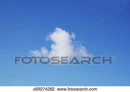 Stock Image - White cumulus cloud on blue sky. Fotosearch