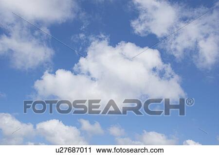 Stock Image - White cumulus clouds on blue sky. Fotosearch