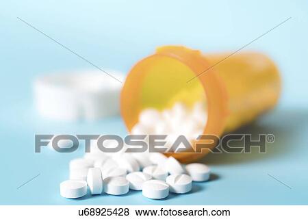 Stock Photo - White pills spilling from bottle.. Fotosearch