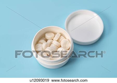 Stock Photo - White tablets in a plastic container.. Fotosearch