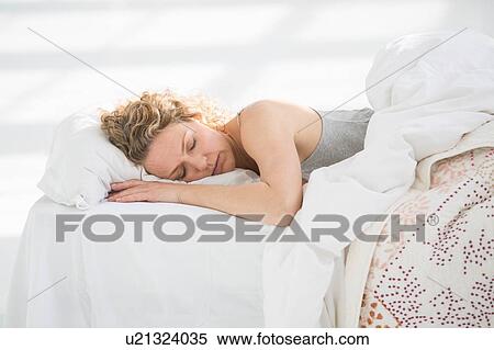 Woman at home, sleeping in bed View Large Photo Image Stock Photography - Woman at home, sleeping in bed. Fotosearch