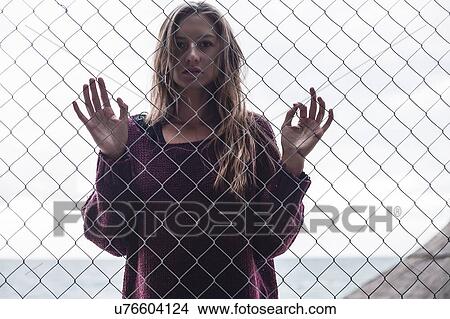 Woman behind fencing, Odessa, Odes'ka Oblast', Ukraine View Large Photo Image Picture - Woman behind fencing, Odessa, Odes'ka Oblast', Ukraine. Fotosearch