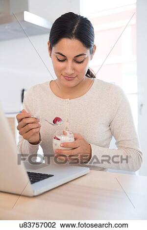 Woman eating fruits and yoghurt View Large Photo Image Stock Image - Woman eating fruits and yoghurt. Fotosearch