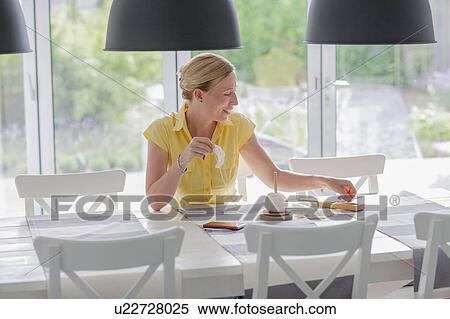 Stock Photography - Woman embroidering at home. Fotosearch