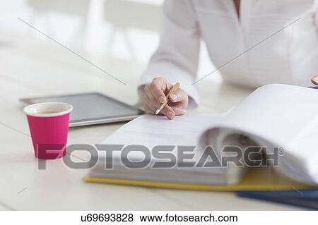 Stock Photo - Woman filling documents. Fotosearch