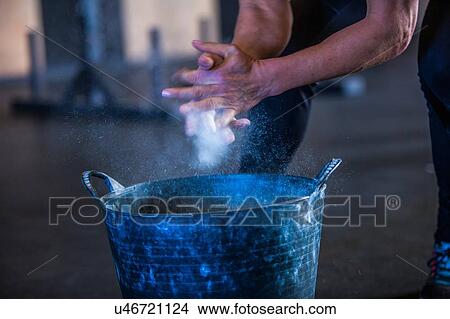 Woman in gymnasium, dusting hands with chalk, mid section View Large Photo Image Picture - Woman in gymnasium, dusting hands with chalk, mid section. Fotosearch