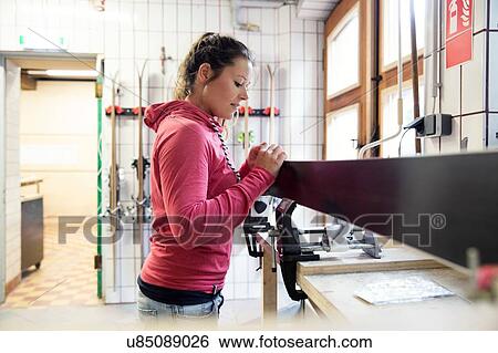 Woman in workshop, inspecting ski equipment View Large Photo Image Stock Photograph - Woman in workshop, inspecting ski equipment. Fotosearch