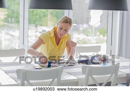 Stock Image - Woman making quilt. Fotosearch