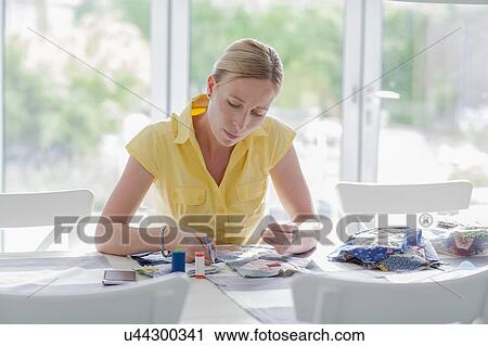 Stock Image - Woman making quilt. Fotosearch