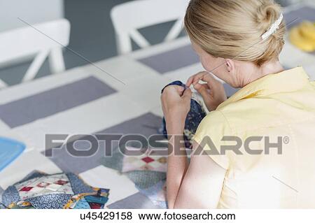 Woman making quilt View Large Photo Image Stock Photo - Woman making quilt. Fotosearch