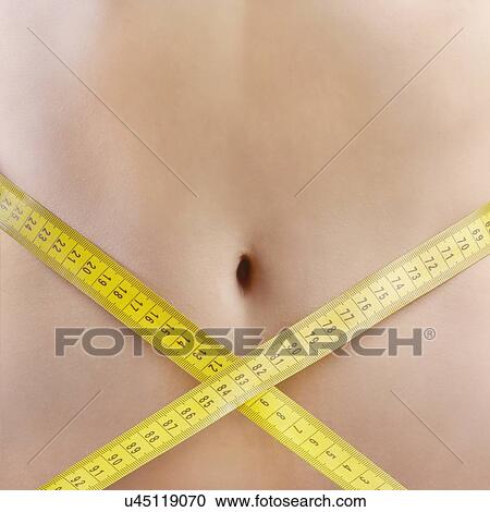 Stock Image - Woman measuring waist.. Fotosearch