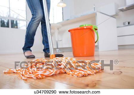 Woman mopping kitchen floor, low section View Large Photo Image Stock Image - Woman mopping kitchen floor, low section. Fotosearch