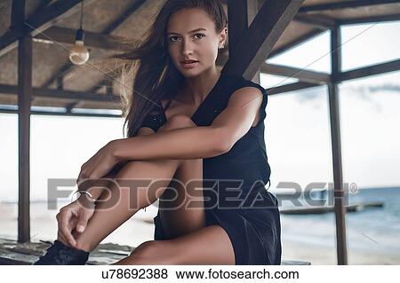 Stock Photo - Woman on bar top of cabana at seaside, Odessa, Odes'ka Oblast', Ukraine. Fotosearch