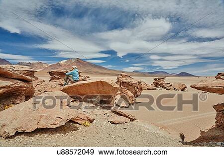 Woman sitting on rock, looking at view, Villa Alota, Potosi, Bolivia, South America View Large Photo Image Stock Photo - Woman sitting on rock, looking at view, Villa Alota, Potosi, Bolivia, South America. Fotosearch