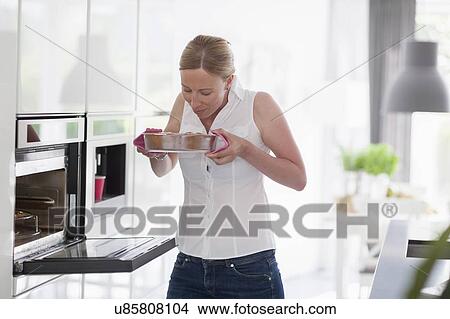 Woman smelling freshly baked cake View Large Photo Image Picture - Woman smelling freshly baked cake. Fotosearch