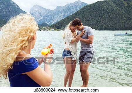 Woman squirting water pistol at friends, Innsbruck, Tirol, Austria, Europe View Large Photo Image Picture - Woman squirting water pistol at friends, Innsbruck, Tirol, Austria, Europe. Fotosearch